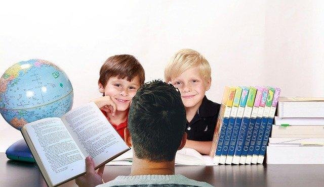 A group of kids reading a book

Description automatically generated with low confidence