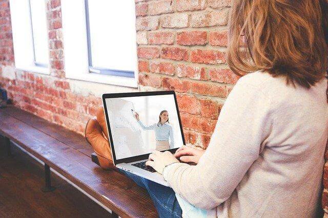 A person sitting at a table using a computer

Description automatically generated with medium confidence