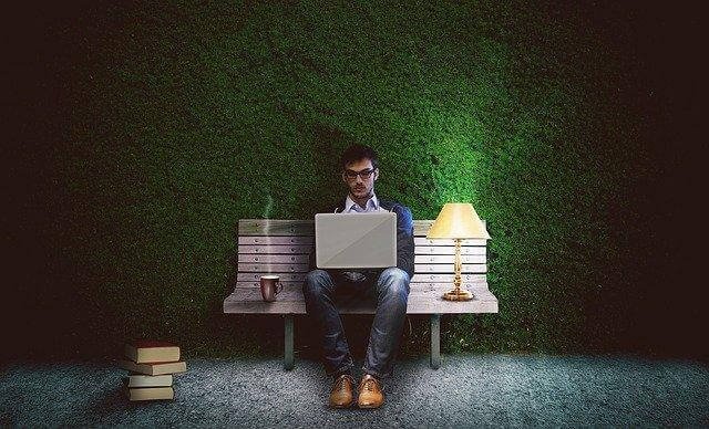 A person sitting on a chair with a computer in front of him

Description automatically generated with medium confidence