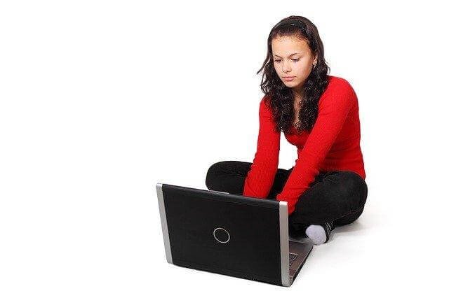 A person sitting on a computer

Description automatically generated with medium confidence